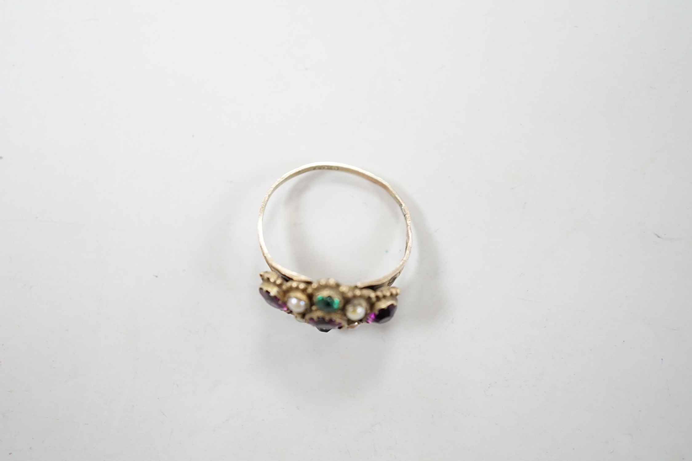 An early 20th century 9ct and coloured paste set ring, in the Suffragette colours, size N, gross weight 2.3 grams.